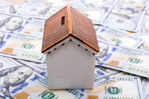 Model house is placed US dollar Banknotes on spread on the background