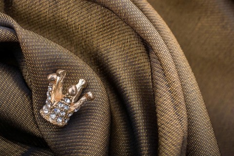 Little model crown placed on a linen canvas