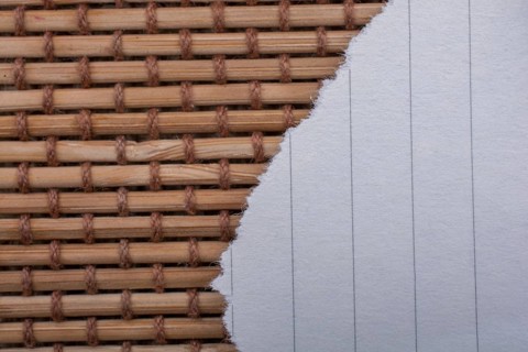 Piece of torn paper on a straw background
