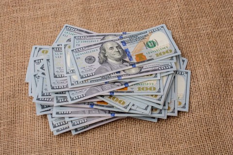 Banknote bundle of US dollar placed on a linen canvas