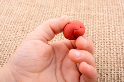 Hands holding Play Dough as Concept of sensetive education and therapy