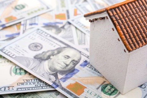 Model house is placed US dollar Banknotes on spread on the background