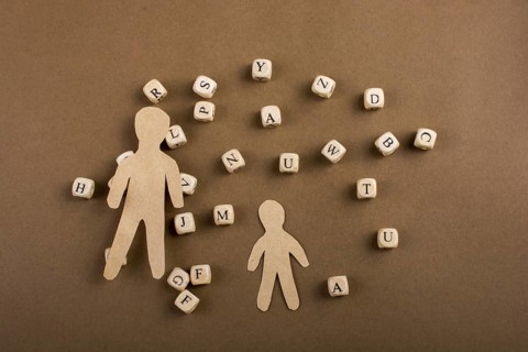 Letter cubes of made of wood and men figurine