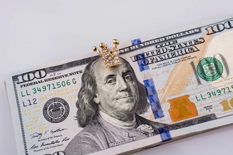American 100 dollar banknotes and a gold color crown