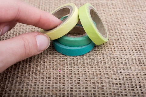 Colorful insulating adhesive tapes on linen canvas background
