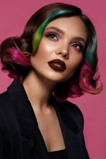 Portrait of beautiful woman with multi-colored hair and evening make-up and hairstyle. Beauty face