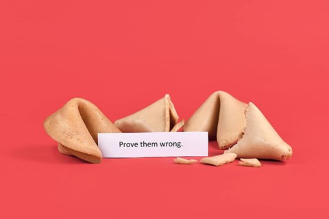 Fortune cookies with motivational text saying 'Prove them wrong' on red background