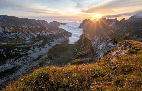 View over Saentis mountains into the valley of Meglisalp at sunrise