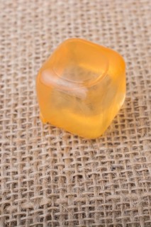 Fake colorful ice cube on a linen canvas