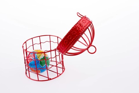 Small globe trapped in a red birdcage