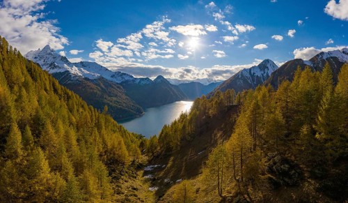 Aerial view over the autumnal forest at Lago di Luzzone in Valle di Blenio
