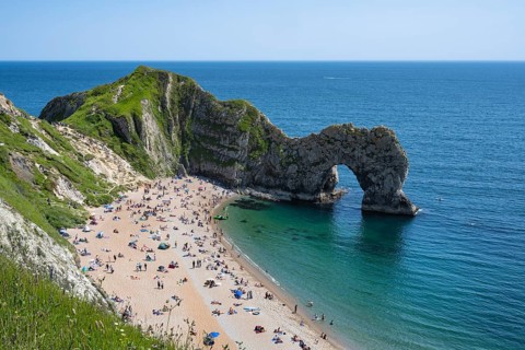 Bathing beach at the famous rock bridge Durdledoor
