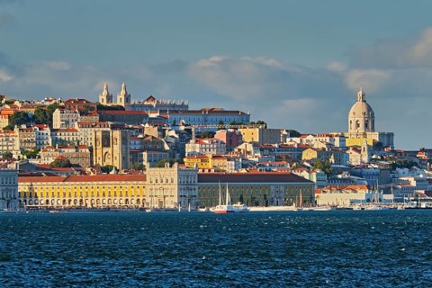 View of Lisbon over Tagus river from Almada with yachts tourist boats on sunset. Lisbon