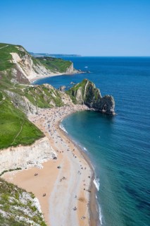 View over the chalk coast with the famous rock bridge Durdledoor