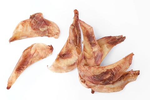 Top view of natural dried treats for dogs. Dried cartilage for dogs isolated on white background