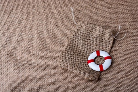 Life preserver on a sack on canvas background
