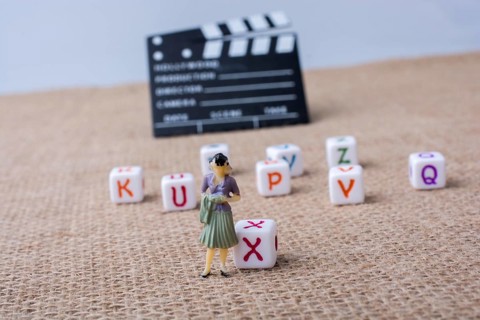 Colorful letter cubes beside a director clapper board