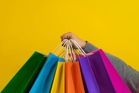 Shopping bags in the woman hands. Joy of consumption. Purchases