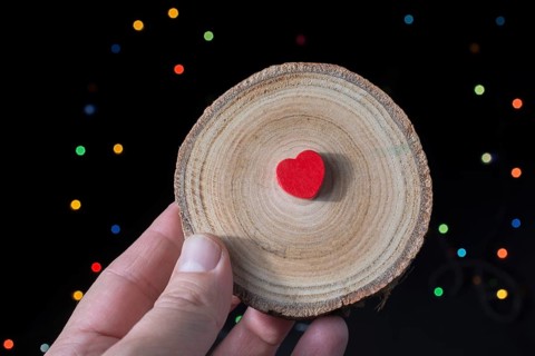 Heart shaped objectin hand on bokeh light background