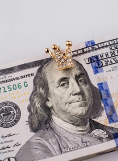 American 100 dollar banknotes and a gold color crown