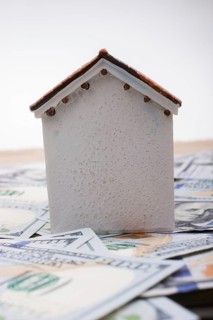 Model house is placed US dollar Banknotes on spread on the background
