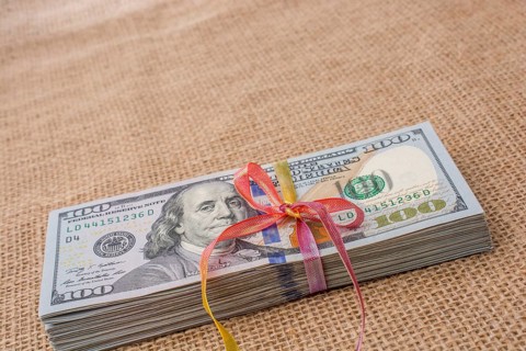 Banknote bundle of US dollar tied with colorful a ribbon