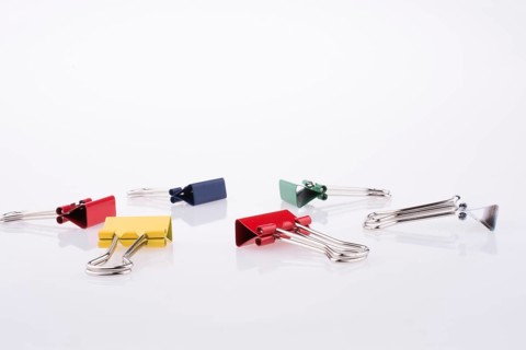 Colored paper clips on a white background
