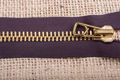 Closeup of a colorful zipper on linen canvas