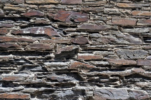 Slate slabs stacked to form a house wall