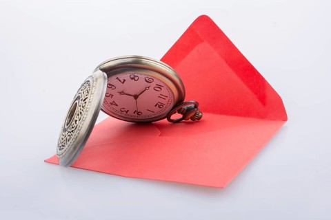 Mechanical pocket watch on a red envelope