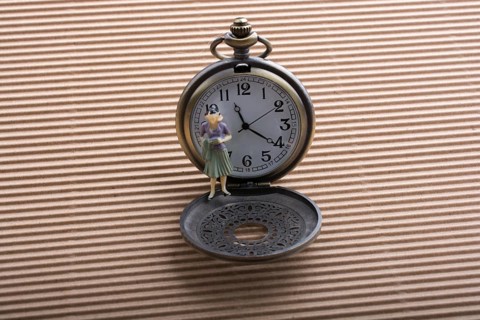 Paper woman shape and a retro pocket watch