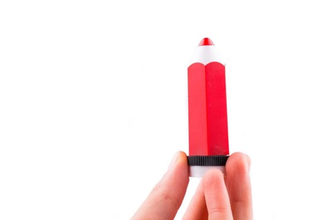 Hand holding a red model pencil in hand on white background