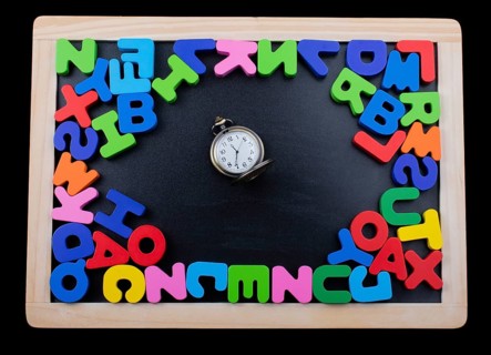 Pocket watch and colorful Letters of Alphabet made of wood