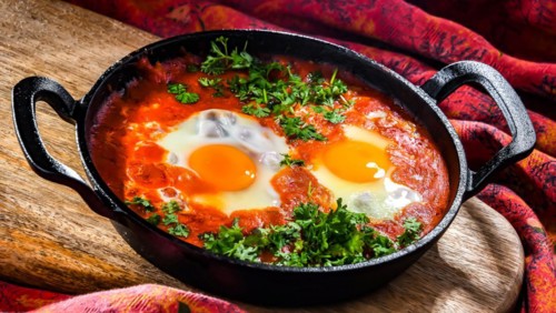 Shakshouka dish in a cast iron pan