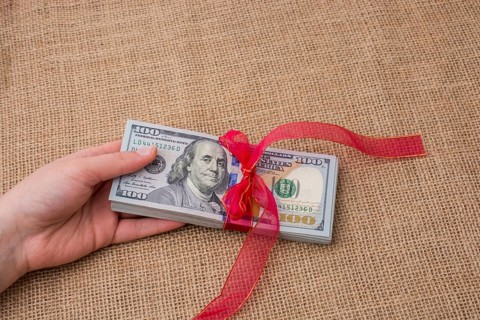 Banknote bundle of US dollar tied with colorful a ribbon