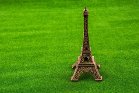 Little Eiffel Tower model on green grass