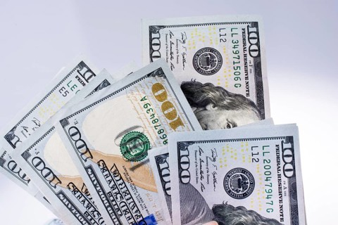 American 100 dollar banknotes made of paper placed on white background