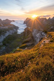 View over Saentis mountains into the valley of Meglisalp at sunrise