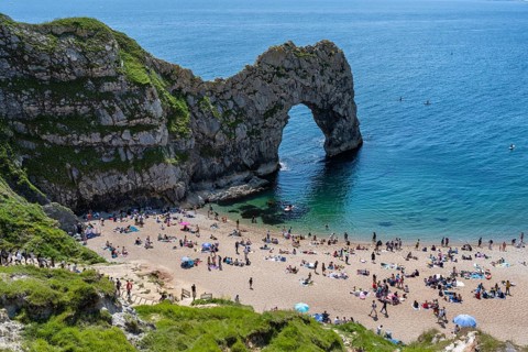 Bathing beach at the famous rock bridge Durdledoor