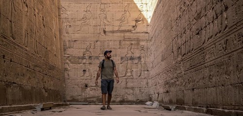 A young tourist visiting the beautiful temple of Edfu in the city of Edfu