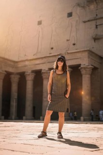 A young tourist wearing a cap visiting the Edfu Temple at sunrise in Aswan. Egypt
