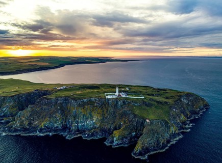 Sunset over Mull of Galloway Lighthouse from a drone