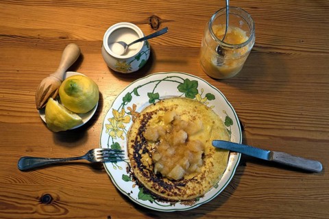 Pancakes with apple sauce and lemon on a plate