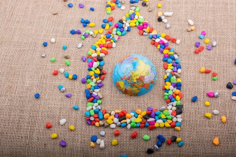 Globe in the house form shaped by colorful pebbles