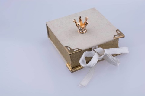 Book model and Golden color crown model with pearls on white background
