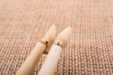 Wooden dolls posing with his legs on canvas