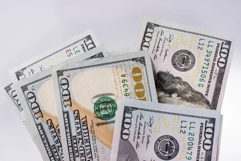 American 100 dollar banknotes made of paper placed on white background