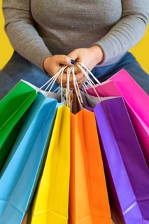Shopping bags in the woman hands. Joy of consumption. Purchases