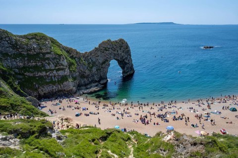 Bathing beach at the famous rock bridge Durdledoor