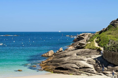 Bay with sandy beach and granite rocks
